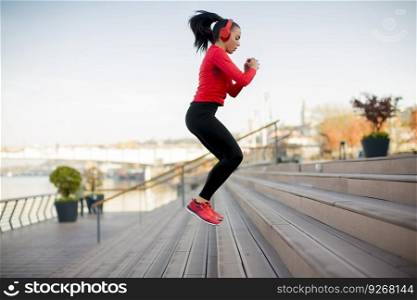 Sporty young woman jumping outdoor