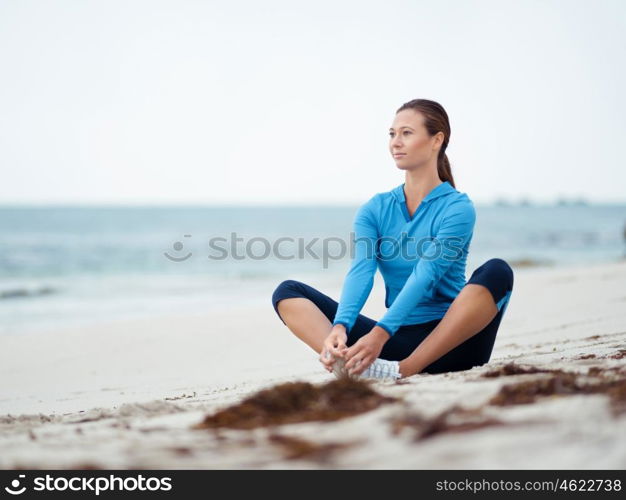 Sporty young woman on the sea coast