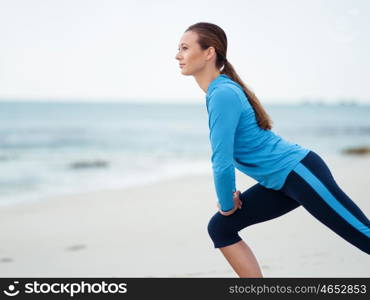 Sporty young woman on the sea coast