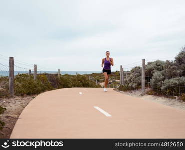 Sporty young woman on the sea coast