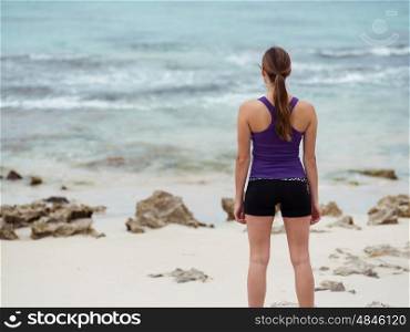 Sporty young woman on the sea coast