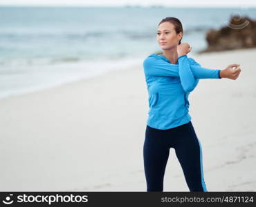 Sporty young woman on the sea coast