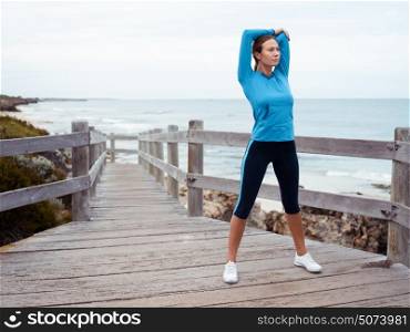 Sporty young woman on the sea coast