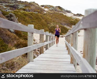 Sporty young woman running up the stairs