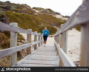 Sporty young woman running up the stairs