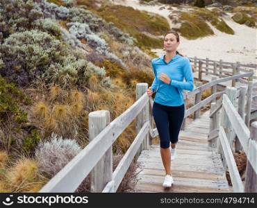 Sporty young woman running up the stairs