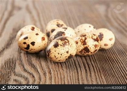 Spotted quail eggs on a wooden table