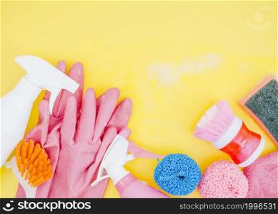 spray bottle brush sponge pink gloves yellow backdrop