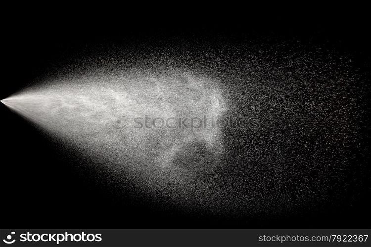 Spraying of water in motion on black background.