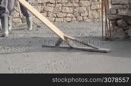 Spreading concrete, compacting liquid cement