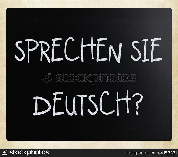 ""Sprechen Sie Deutsch?" handwritten with white chalk on a blackboard"