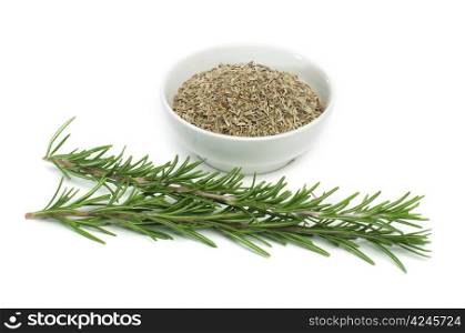 Sprig fresh rosemary and a bowl with dried rosemary