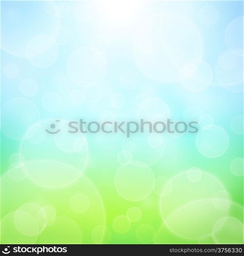 Spring abstract background with bokeh and sun rays. Grass and blue sky