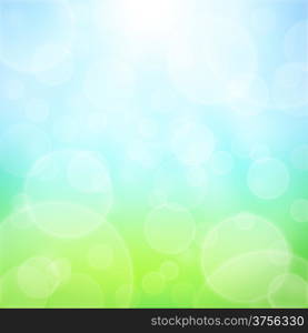 Spring abstract background with bokeh and sun rays. Grass and blue sky