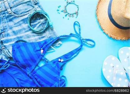 Spring and summer blue collection of girl accessories, Flat lay on blue background