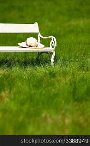 Spring and summer - White romantic bench in meadow on sunny day