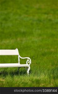Spring and summer - White romantic bench in meadow on sunny day