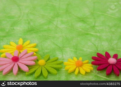 Spring background. Flowers on green sisal background, selective DOF.