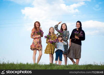 spring - beautiful happy girls at the green field