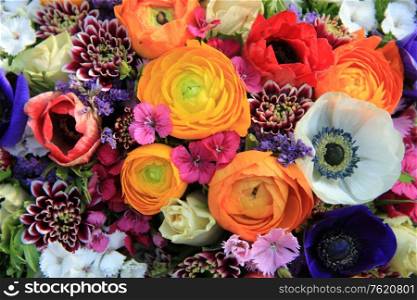 Spring bouquet with ranunculus and anemones in bright colors