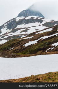 Spring cloudy overcast mountain landscape (Oberalp Pass, Switzerland)