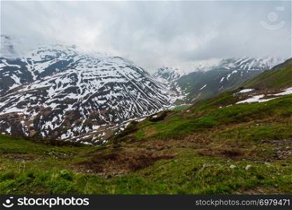 Spring cloudy overcast mountain landscape (Oberalp Pass, Switzerland)