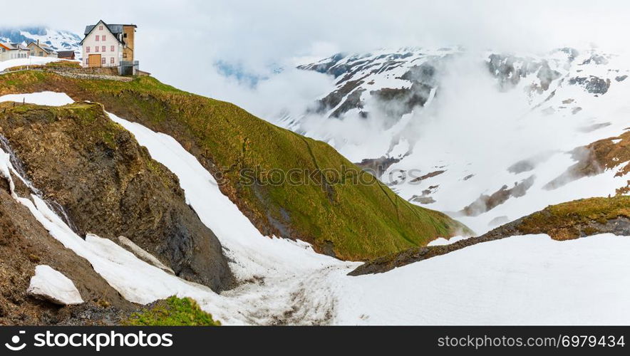 Spring cloudy overcast mountain panorama landscape on Furka Pass, Switzerland.