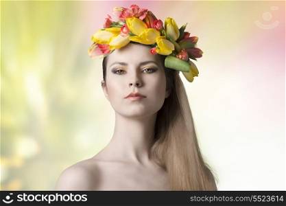 spring concept portrait of sexy woman with naked shoulders, long smooth hair and colorful make-up, wearing floral wreath on her head. Fresh style
