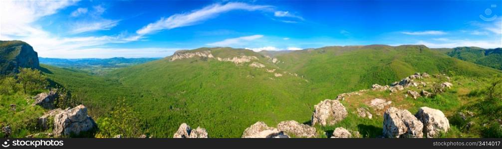 Spring Crimea Mountain country panorama with valley and Sokolinoje Village (Ukraine). Great Crimean Canyon environs. Eight shots stitch image.