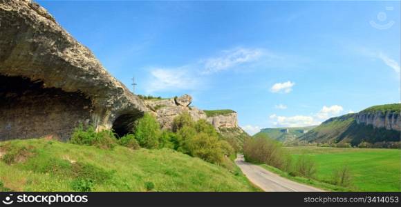 Spring Crimea (Ukraine) landscape with plateau and valley. On the left - ancient cave settlement (Crimea, Ukraine). Two shots stitch image.