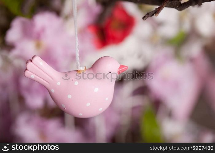 Spring decor - pink birds on the branch in shabby chic cage with flowers. The Spring decor