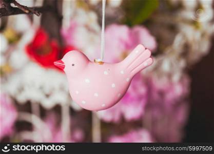 Spring decor - pink birds on the branch in shabby chic cage with flowers. The Spring decor