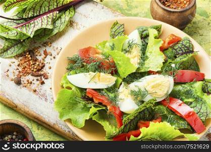 Spring diet salad with greens and egg.Fresh mixed green salad with egg. Healthy and tasty salad