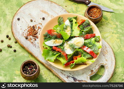 Spring diet salad with greens and egg.Salad with egg,sorrel and pepper. Vegetable salad with egg