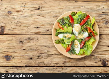 Spring diet salad with greens and egg.Salad with egg,sorrel and pepper. Vegetable salad with egg