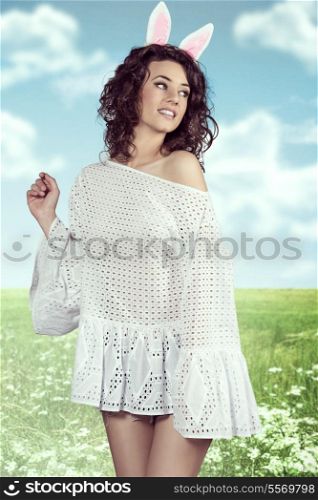 Spring easter portrait of pretty brunette girl with curly hair-style and rabbit ears