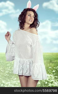 Spring easter portrait of pretty brunette girl with curly hair-style and rabbit ears