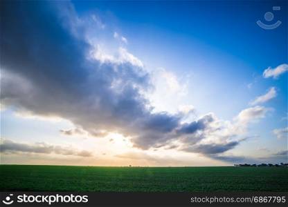 spring farm fields with sunset and clouds in texas