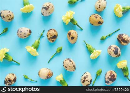 Spring floral and eggs backdrop or wallpaper. Yellow flowers and organic natural quail eggs on blue background. Happy Easter, zero waste concept Creative Flat lay Top view Template for your design.. Spring floral and eggs backdrop or wallpaper. Yellow flowers and organic natural quail eggs on blue background. Happy Easter, zero waste concept Creative Flat lay Top view Template for your design