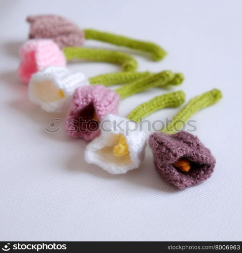 Spring flower for springtime, colorful handmade tulip on white background, diy product by knit can make gift for woman day or mother day