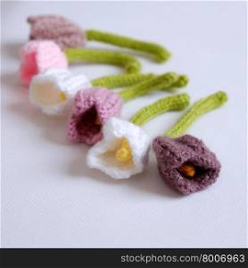 Spring flower for springtime, colorful handmade tulip on white background, diy product by knit can make gift for woman day or mother day