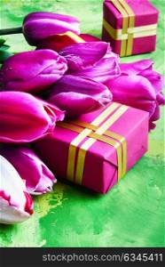 Spring flowers and gift box. Bouquet of purple tulips and gift box.Women day celebration concept