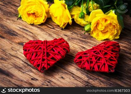 Spring flowers and symbolic red hearts. Bouquet of yellow roses and symbolic red hearts.Postcard for Valentine Day