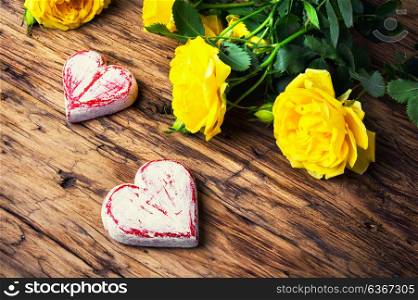 Spring flowers and symbolic red hearts. Bouquet of yellow roses and symbolic red hearts.Postcard for Valentine Day