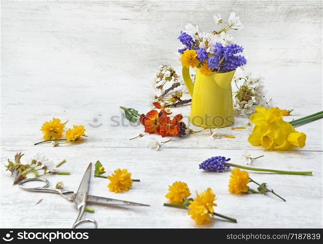 spring flowers picked from garden and arranged on a table to make bouquet at home