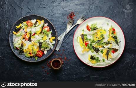 Spring fresh vegetable salad on rice paper.Vegetable oriental salad.. Vegetarian spring salad with fresh vegetables