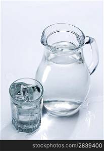 Spring fresh water in the glass with ice cubes