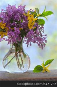 Spring Lilac bouquet on the wooden table. Lilac bouquet on the wooden table