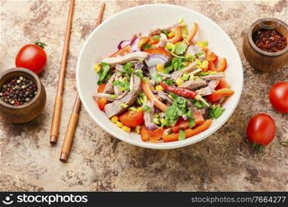 Spring meat salad with beef,pepper,tomato and corn.Asian salad.. Asian salad with vegetables and meat