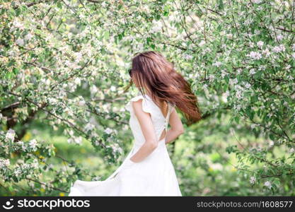 Spring mood, beautiful woman smell flowering tree, enjoying nature, white floral garden. Beautiful woman enjoying smell in spring cherry garden. Beautiful woman enjoying smell in spring cherry garden